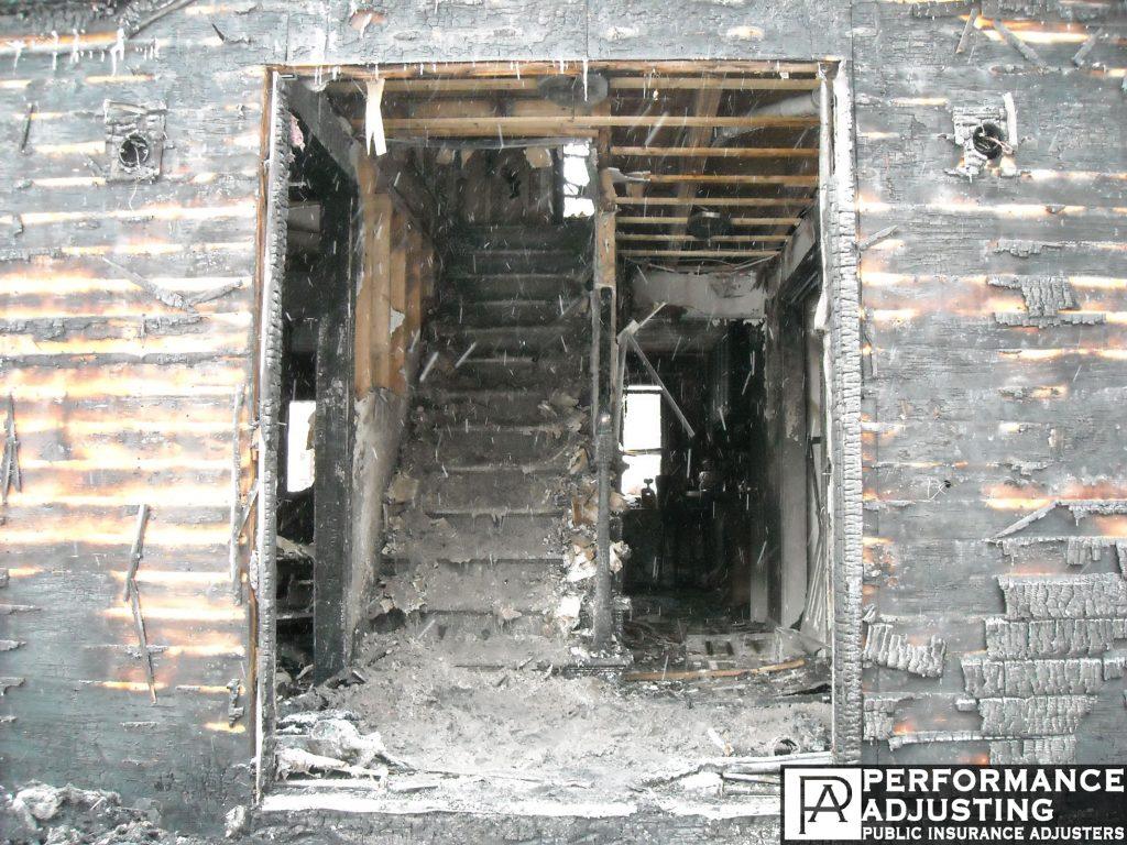 a burned building covered in ash after a fire