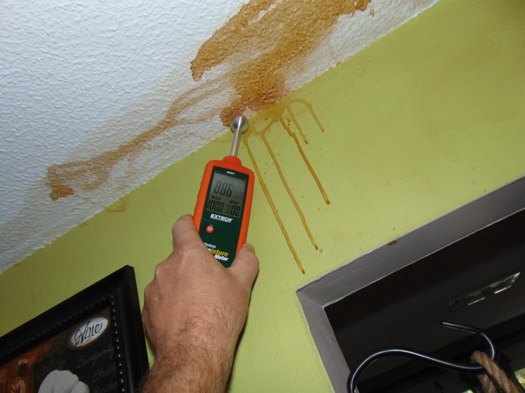 Man assessing water damage in Warwick, Rhode Island
