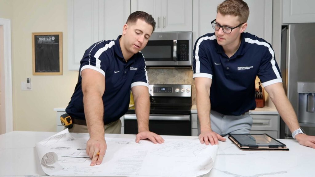 public adjusters looking at plans on a kitchen counter in rhode island